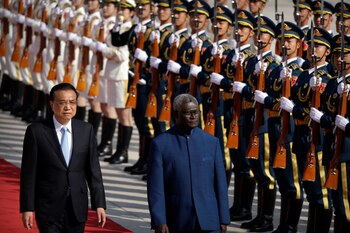 FILE - Chinese Premier Li Keqiang, left, and Solomon Islands Prime Minister Manasseh Sogavare review an honor guard during a welcome ceremony at the Great Hall of the People in Beijing, Wednesday, Oct. 9, 2019. The U.S. on Monday, April 18, 2022, announced it is sending two top officials to the Solomon Islands following a visit last week by an Australian senator over concerns that China could establish a military presence in the South Pacific island nation. (AP Photo/Mark Schiefelbein, File)