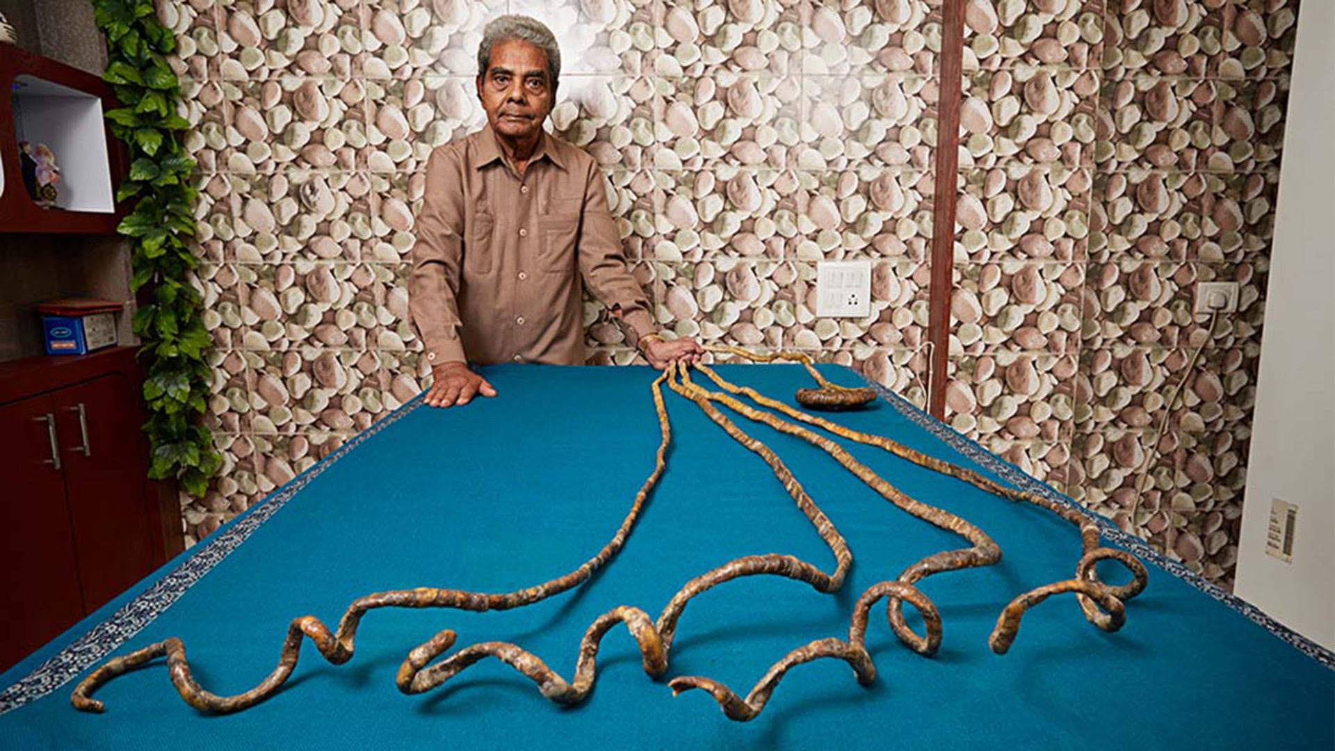 Shridhar Chillal obtuvo un récord Guinness por las uñas más largas en una sola mano, con 909,6 centímetros en la mano izquierda (Créditos: Guinness World Records)