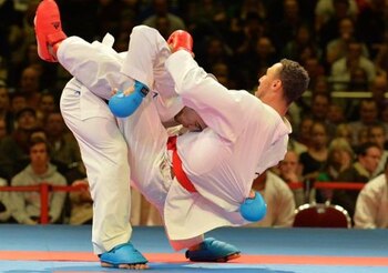 Jonathan Horne (R) from Germany and Doorshab from Iran fight at the final of the Team male Kumite competition of the 22nd Karate World Championships at OVB-Arena on November 9, 2014 in Bremen, Germany. AFP PHOTO / CARMEN JASPERSEN (Photo credit should read CARMEN JASPERSEN/AFP/Getty Images)