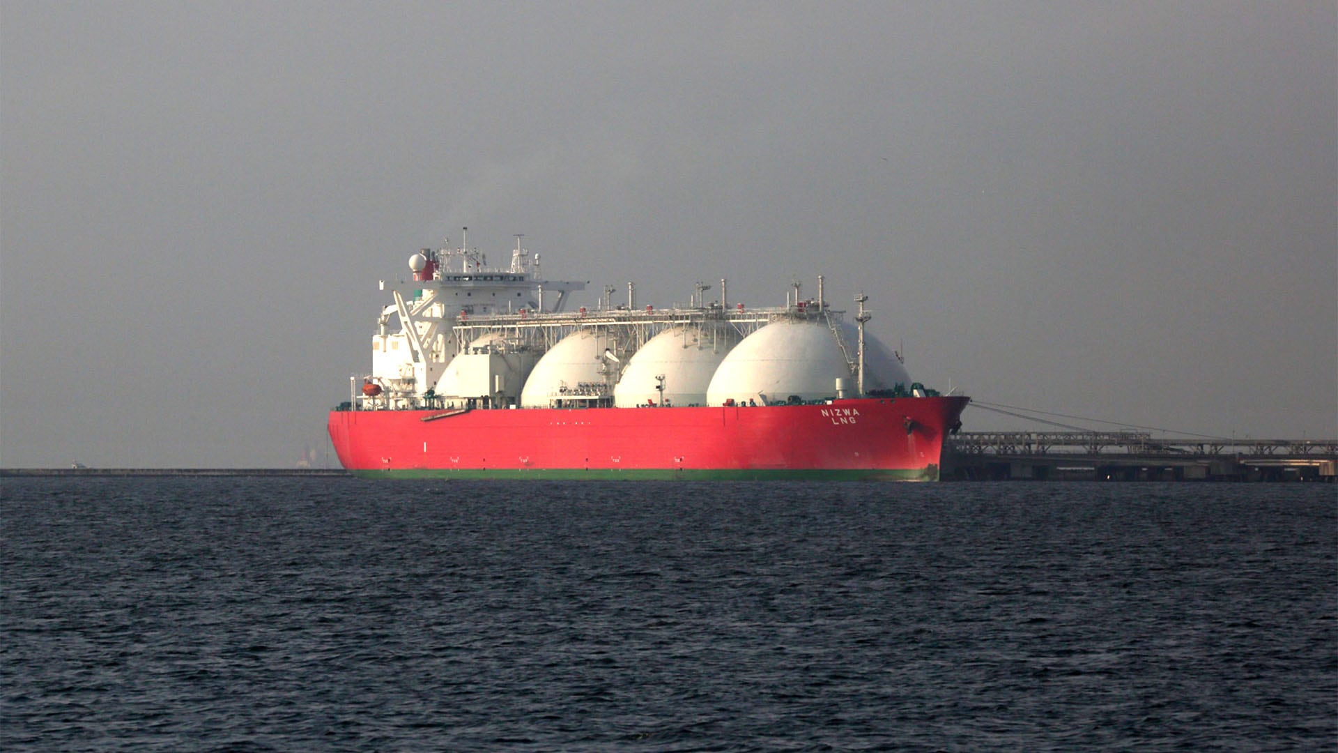 A liquefied natural gas (LNG) tanker is berthed at Tokyo Electric Power Co.'s Futtsu gas-fired thermal power plant in Futtsu, Chiba Prefecture, Japan, on Monday, July 21, 2014. Japan's trade deficit was larger than forecast after exports unexpectedly fell, dragging on an economy squeezed by a sales-tax increase in April. Photographer: Tomohiro Ohsumi/Bloomberg