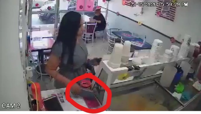 Cámaras de seguridad captaron a una mujer escondiendo discretamente el aparato dentro de una nevería. (Captura de pantalla)