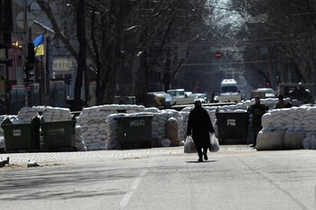 An elderly woman walks near