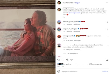 Hombre y mujer sentados de perfil en un barco, el hombre abraza a la mujer. Se observa el mar y un barandal. Parte de una publicación de Instagram