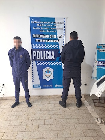 Dos personas, con rostros pixelados, sostienen pistolas y revólveres en una foto. Uno lleva capucha y bufanda; el otro está parcialmente visible. El fondo es oscuro