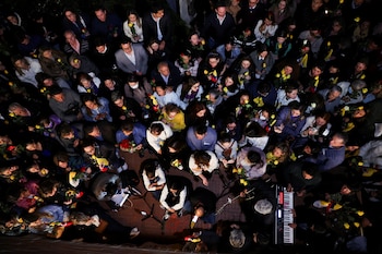 People attend a Mass outside