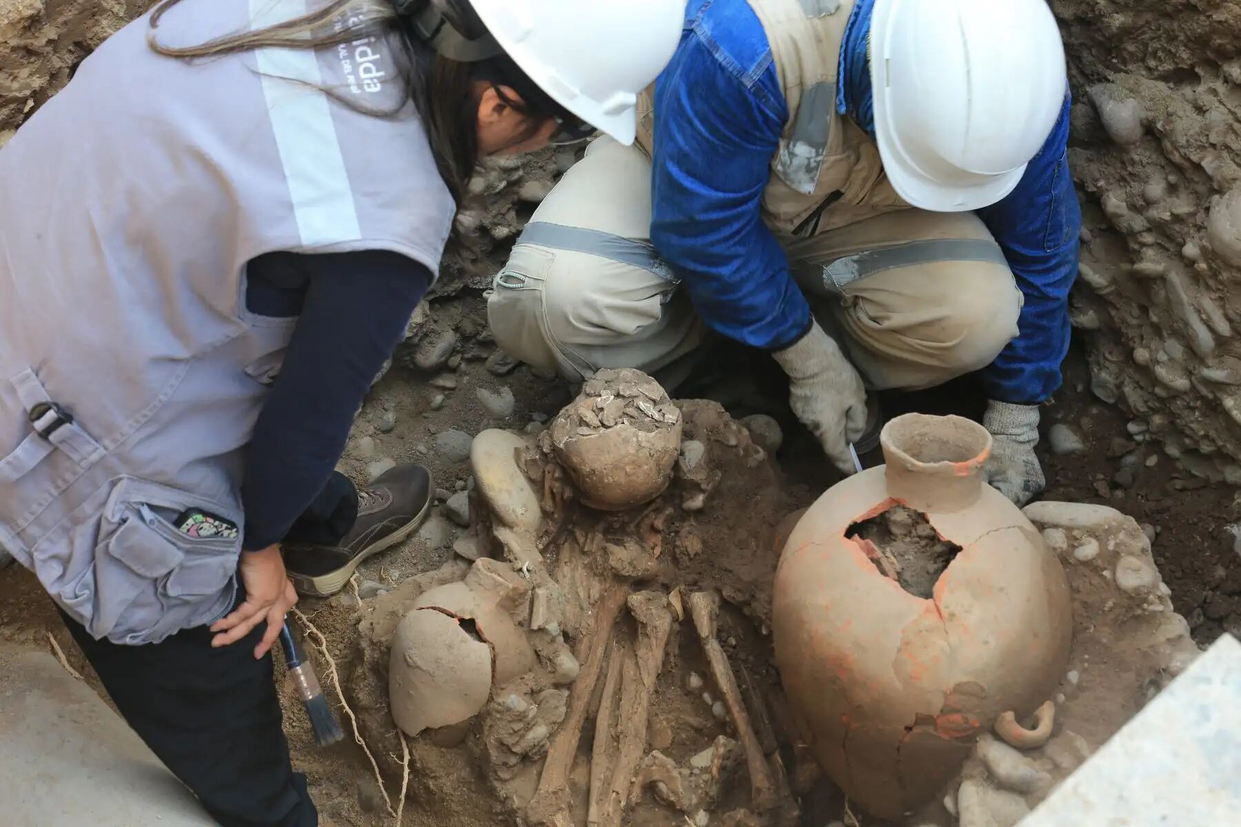 Arqueólogos supervisan el hallazgo de un entierro prehispánico de la cultura Blanco sobre Rojo, con los restos de un joven y un ajuar funerario, descubierto en San Isidro durante obras de ampliación de red de gas. (Foto: Agencia Andina)