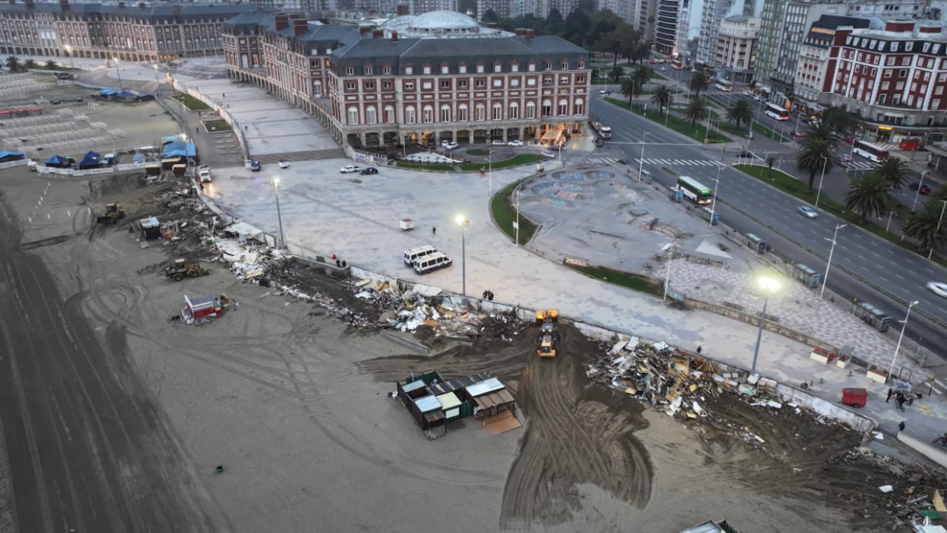 Vista aérea de maquinaria pesada retirando escombros en la icónica playa marplatense