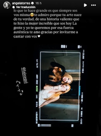 Dos mujeres jóvenes con cabello rubio/castaño claro se abrazan y sonríen. Una mujer de negro abraza a otra de blanco, que tiene una mano cerca de la boca