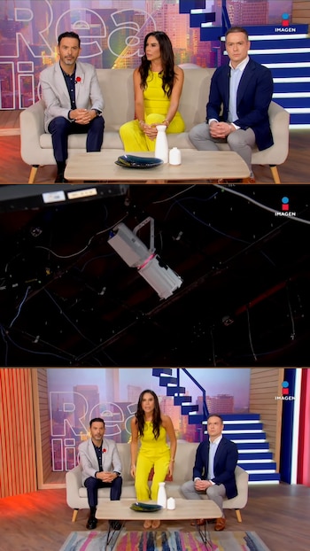 Tres presentadores de televisión en un sofá; una lámpara de estudio temblando en un techo oscuro; la presentadora de amarillo de pie, visiblemente reaccionando