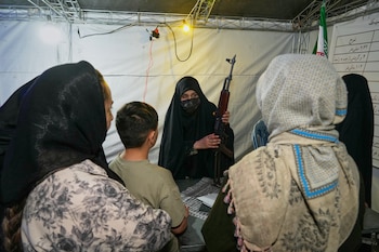 Un miembro de la fuerza de voluntarios Basij, perteneciente a la Guardia Revolucionaria Islámica, muestra cómo manejar un fusil de asalto tipo Kalashnikov durante una clase de entrenamiento con armas en Teherán, Irán, el martes 19 de mayo de 2026 (AP/Vahid Salemi)