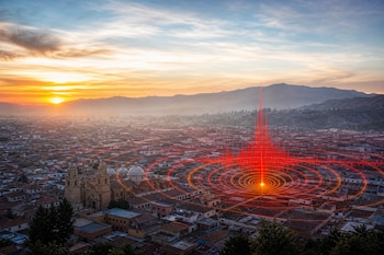 Vista panorámica de una ciudad con un gráfico digital de ondas rojas concéntricas que emanan de un punto céntrico.
