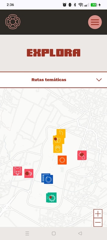 Captura de pantalla de una aplicación móvil con un mapa de calles y áreas verdes. Muestra iconos coloridos de animales, naturaleza y símbolos. Texto: 'EXPLORA', 'Rutas temáticas'