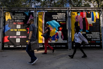 Pedestrians walk past a TIFF
