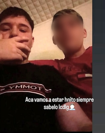 Dos jóvenes posan para una fotografía, uno con la mano sobre la boca y otro con el rostro difuminado, junto a un texto superpuesto