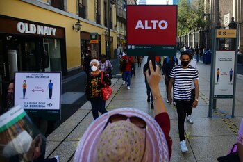 An employee holds a sign