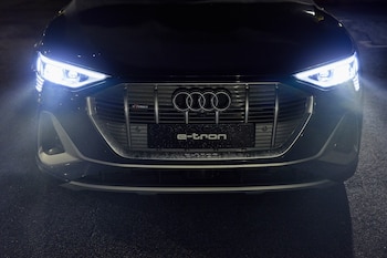 FILE — An Audi e-tron Sportback with smart headlights in Los Angeles, Dec. 17, 2021. Smart headlights that steer light away from oncoming traffic have finally been approved for American roads, and carmakers are slowly incorporating them into new models. (Stella Kalinina/The New York Times)