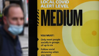 A pedestrian wearing a face