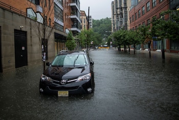 A car is seen on a flooded street as Tropical Storm Elsa passes through Hoboken, New Jersey, U.S., July 9, 2021. REUTERS/Eduardo Munoz
