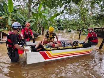 Una mujer de la tercera edad es sacada en un bote de rescate de su vivienda, donde el agua llegó hasta su cintura, en la zona norte de Costa Rica. (Infobae Centroamérica/Cortesía Cruz Roja Costarricense y Bomberos Costa Rica)