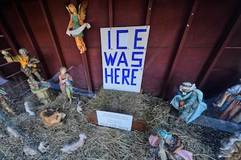Un letrero que dice "El ICE estuvo aquí" (refiriéndose a las siglas en inglés del Servicio de Inmigración y Control de Aduanas de Estados Unidos) yace sobre el espacio vacío para el Niño Jesús en un pesebre de la iglesia de Santa Susana, el martes 9 de diciembre de 2025, en Dedham, Massachusetts. (AP Foto/Charles Krupa)
