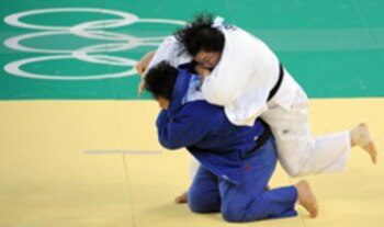 China's Wen Tong (in blue) and Japan's Maki Tsukada compete in their women's +78 kgs judo match of the 2008 Beijing Olympic Games on August 15, 2008 in Beijing. China's Tong Wen won the gold, Japan's Maki Tsukada the silver, while Cuba's Idalys Ortiz and Slovenia's Lucija Polavder won the bronze. AFP PHOTO / JOE KLAMAR (Photo credit should read JOE KLAMAR/AFP/Getty Images)