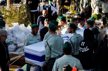 Friends carry the coffin during