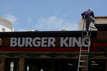 A worker climbs a ladder