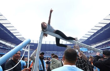 Una fanática colgada del travesaño