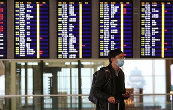 Un pasajero lleva una mascarilla mientras camina por el aeropuerto internacional de Hong Kong, China, el 7 de febrero de 2020. REUTERS/Hannah McKay/Archivos
