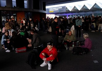 People wait with their luggage