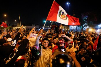 A demonstrator waves a Peruvian