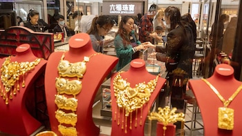 Turistas chinos comprando lingotes y