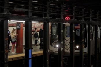 People wait at a subway