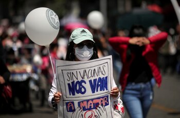 A woman holds a poster