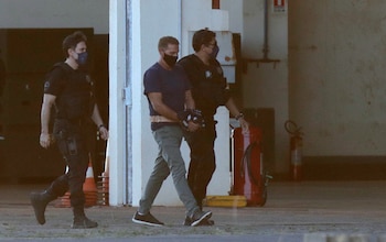 El narcotraficante italiano Rocco Morabito es escoltado por la policía federal en el hangar de la Policía Federal en Brasilia, Brasil, el 25 de mayo de 2021 (REUTERS/Ueslei Marcelino)