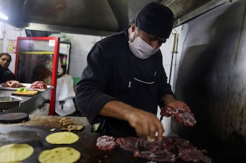 A Taquero prepares the meat for tacos at the Taqueria El Califa de Leon, which recently earned one star in the Michelin Guide, in Mexico City, Mexico, May 16, 2024. REUTERS/Gustavo Graf