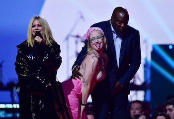 A topless demonstrator is escorted