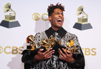 Jon Batiste poses with their