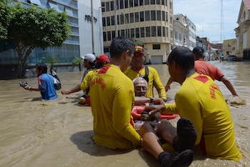 Lifeguards help a man cross