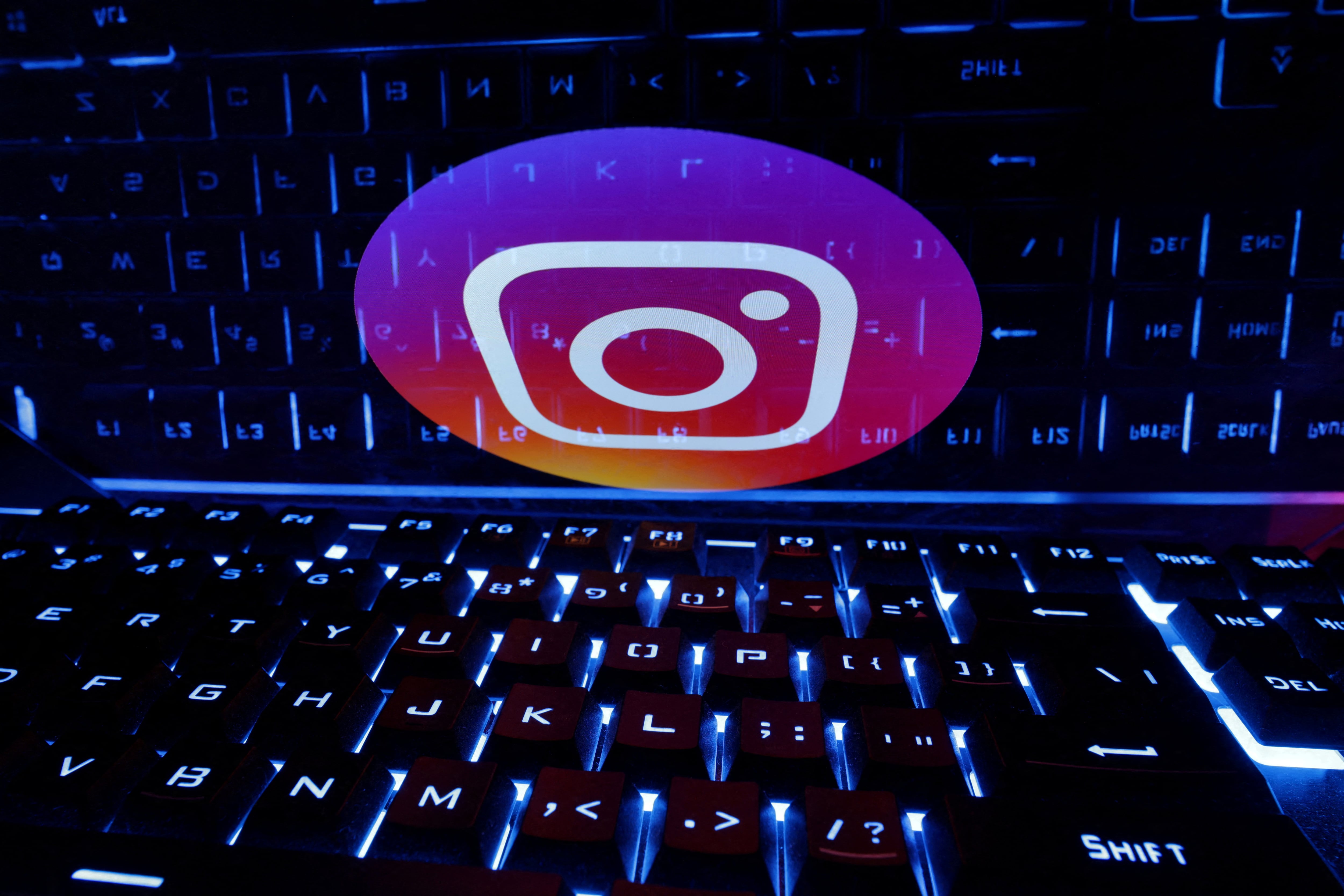 FILE PHOTO: A keyboard is placed in front of a displayed Instagram logo in this illustration taken February 21, 2023. REUTERS/Dado Ruvic/Illustration/File Photo