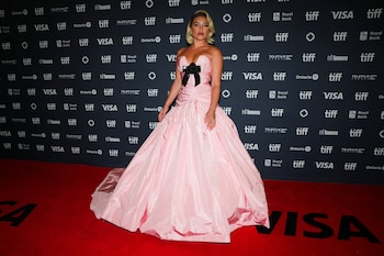 Vestido rosa claro de gala, escote palabra de honor, falda amplia y lazo negro en el busto (REUTERS/Mark Blinch)