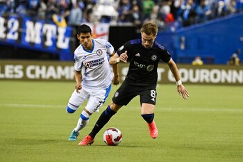Mar 16, 2022; Montreal, Quebec, Canada; CF Montreal midfielder Djordje Mihailovic (8) plays the ball against Cruz Azul forward Uriel Antuna (7) during the first half at Olympic Stadium. Mandatory Credit: David Kirouac-USA TODAY Sports