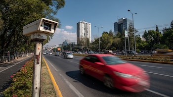 Cámara de fotomulta montada en un poste sobre una calle de la Ciudad de México, apuntando hacia los vehículos en circulación. — (Imagen Ilustrativa Infobae)