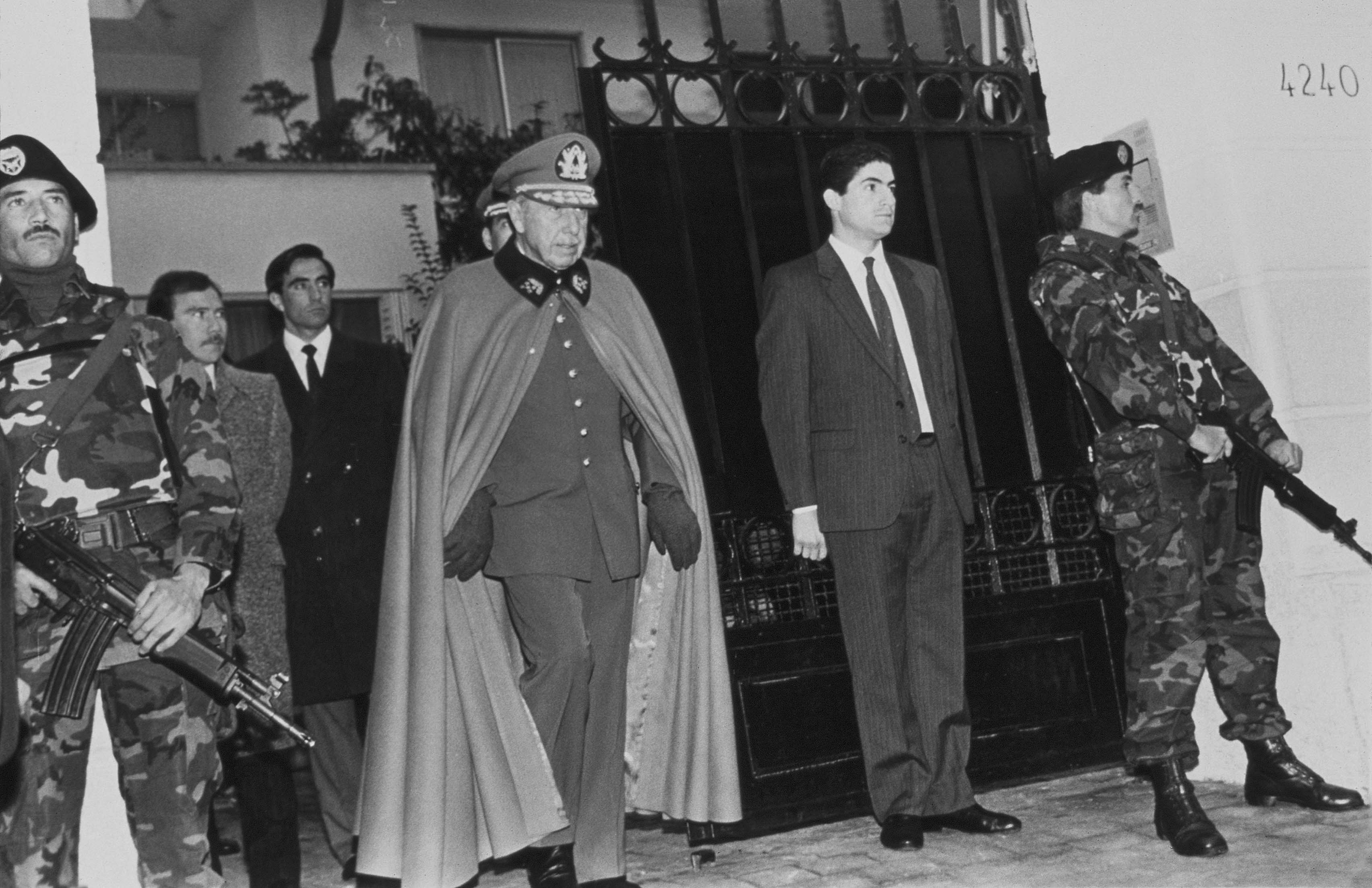 El general Augusto José Ramón Pinochet Ugarte sale de su casa, rodeado de guardas de seguridad, en Santiago, Chile, el día después de sobrevivir a un intento de asesinato del grupo guerrillero Frente Patriótico Manuel Rodríguez (AP Foto/Marco Ugarte)