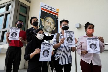 FILE PHOTO: Activists hold posters