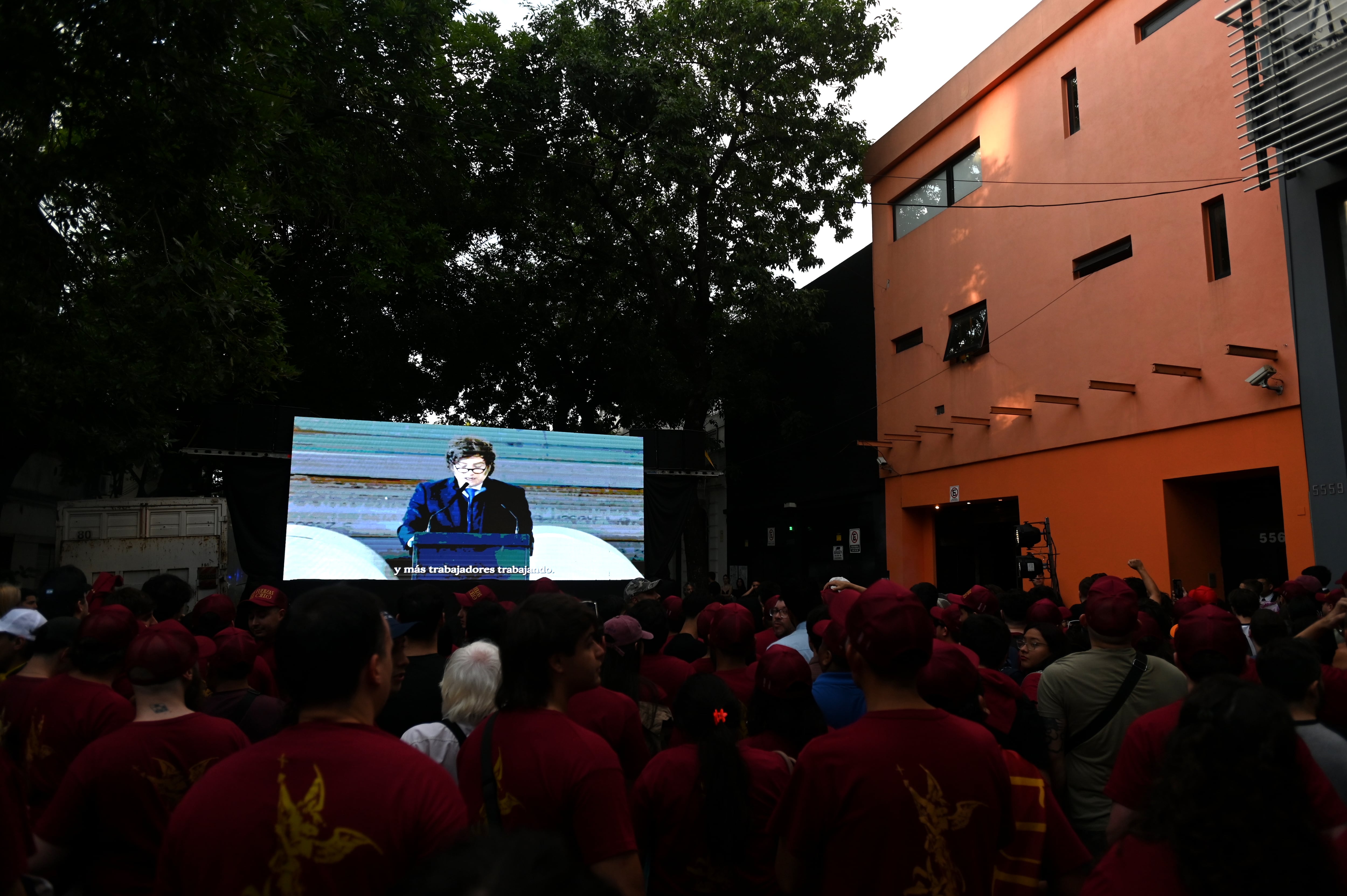 En la previa, los militantes escuchan discursos de Milei desde una pantalla