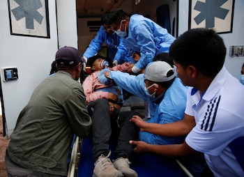 Demonstrators assist an injured man