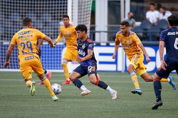 Aug 10, 2021; Seattle, WA, USA; Seattle Sounders FC forward Fredy Montero (12) dribbles between two Tigres UANL players during the first half at Lumen Field. Mandatory Credit: Jennifer Buchanan-USA TODAY Sports