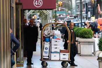 A doorman pulls a luggage