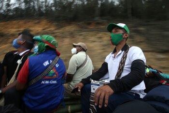 Colombian indigenous people sit on